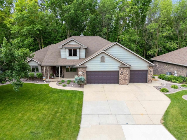 2510 Hillside Heights Dr, Green Bay, WI 54311 - view of front of home featuring a garage, a front lawn, a porch, and driveway