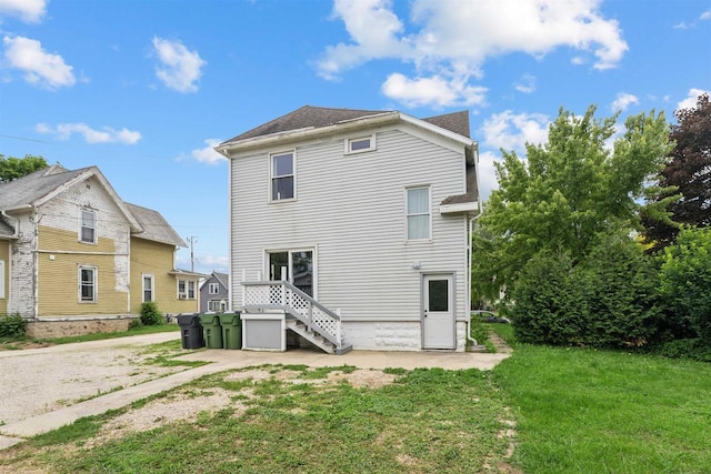 136 Oak St, Brillion, WI 54110 - back of house featuring a yard and roof with shingles