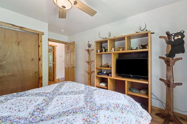 5093 County Highway G, Cavour, WI 54511 - bedroom with wood finished floors, a closet, and ceiling fan