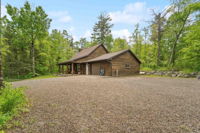 5093 County Highway G, Cavour, WI 54511 - view of side of property featuring an attached garage and gravel driveway