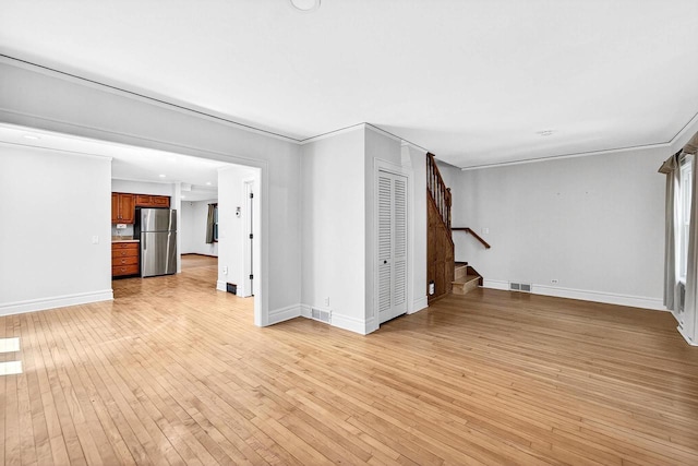 2813 Regent St, Madison, WI 53705 - unfurnished living room featuring stairs, light wood-type flooring, and ornamental molding