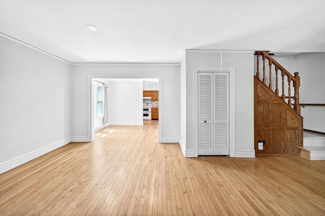 2813 Regent St, Madison, WI 53705 - unfurnished living room with stairway, light wood-type flooring, and ornamental molding