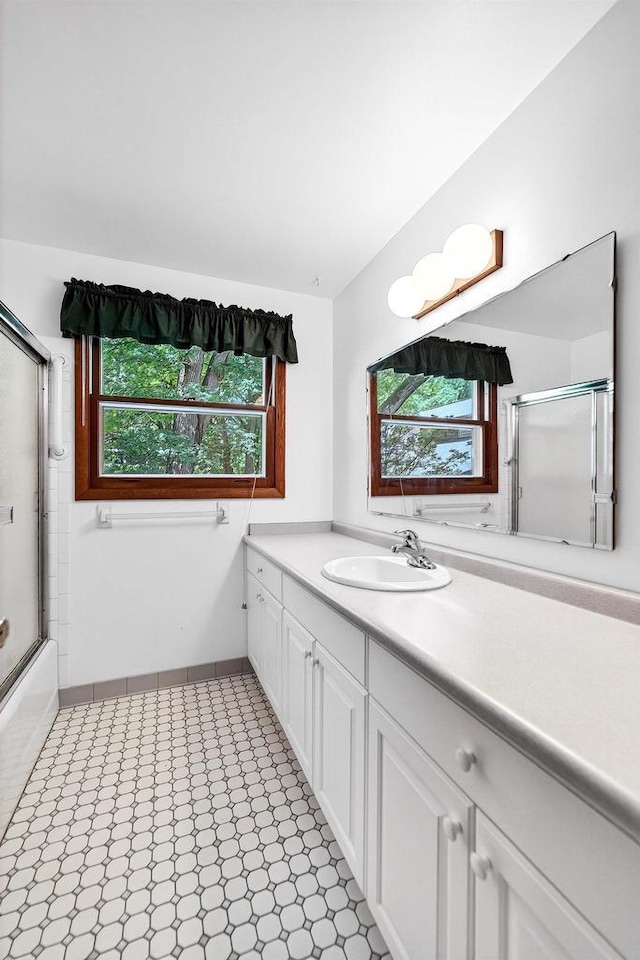 2813 Regent St, Madison, WI 53705 - bathroom featuring vanity, plenty of natural light, and combined bath / shower with glass door