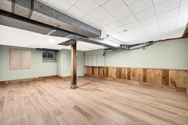 2813 Regent St, Madison, WI 53705 - finished below grade area featuring wood finished floors, wooden walls, and a wainscoted wall