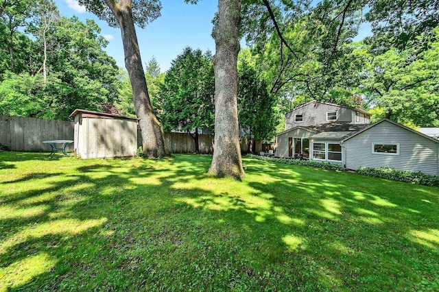 2813 Regent St, Madison, WI 53705 - fenced backyard featuring a storage shed and view of wooded area