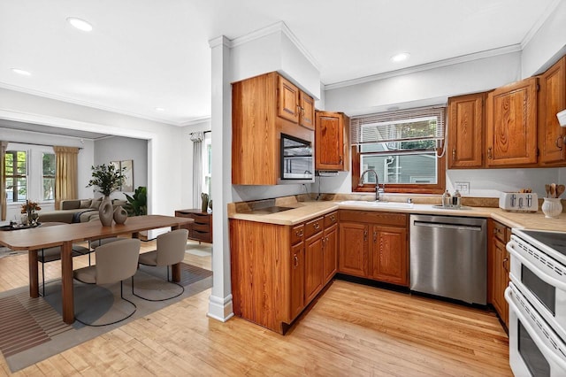 2813 Regent St, Madison, WI 53705 - kitchen with dishwasher, range with two ovens, brown cabinetry, crown molding, and recessed lighting