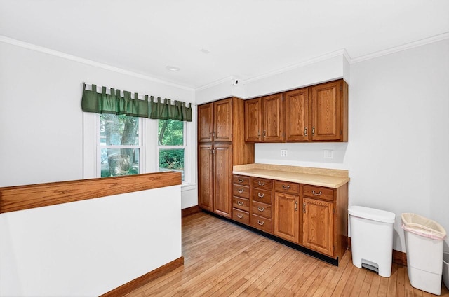2813 Regent St, Madison, WI 53705 - kitchen featuring brown cabinets, crown molding, light countertops, and light wood-style floors