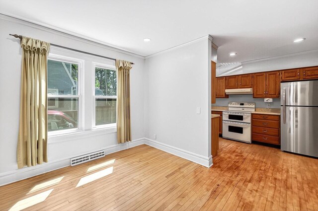 2813 Regent St, Madison, WI 53705 - kitchen with freestanding refrigerator, double oven range, under cabinet range hood, light countertops, and light wood-style floors