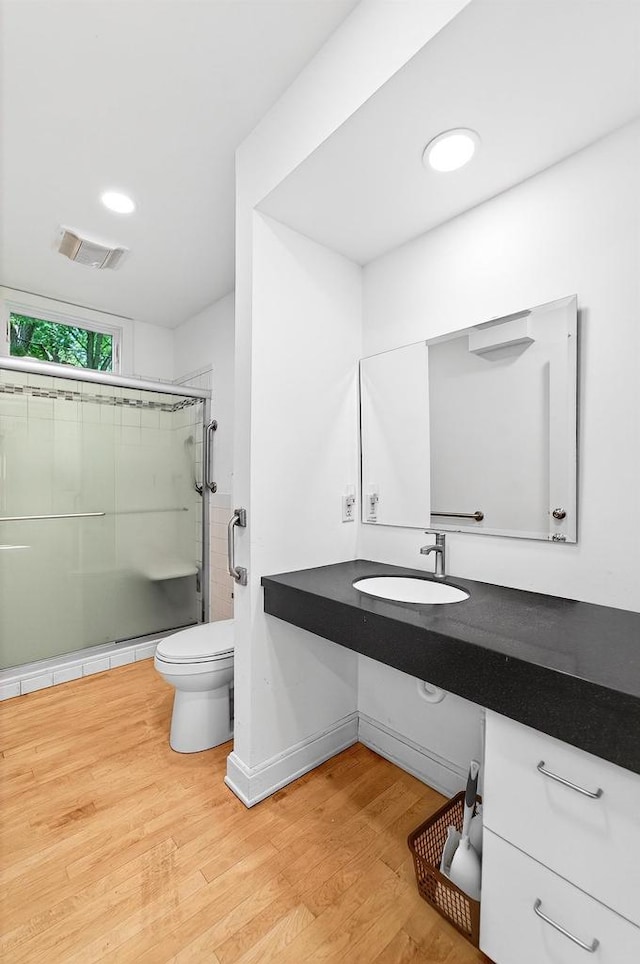 2813 Regent St, Madison, WI 53705 - bathroom with a shower with door, wood finished floors, and vanity