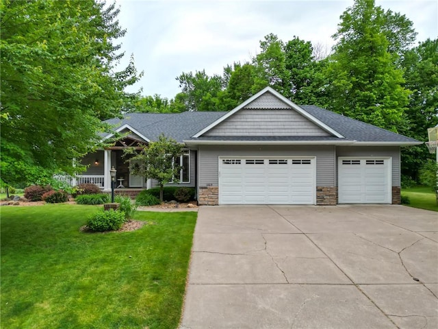 1403 Elm Ave, Menomonie, WI 54751 - craftsman-style home featuring a garage, a front lawn, concrete driveway, covered porch, and a shingled roof