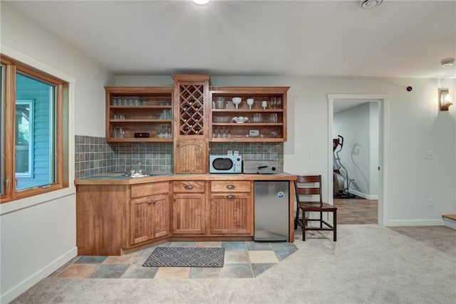 1403 Elm Ave, Menomonie, WI 54751 - kitchen featuring open shelves, refrigerator, backsplash, and brown cabinets