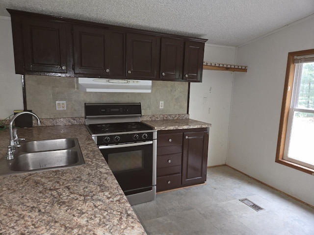 2143 County Road Z, Friendship, WI 53934 - kitchen featuring black gas range oven, under cabinet range hood, dark brown cabinetry, a textured ceiling, and crown molding