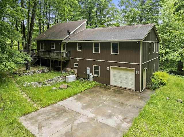 N12757 Rivers Meet Dr, Athelstane, WI 54104 - view of front of home featuring a shingled roof, concrete driveway, an attached garage, a deck, and a front yard