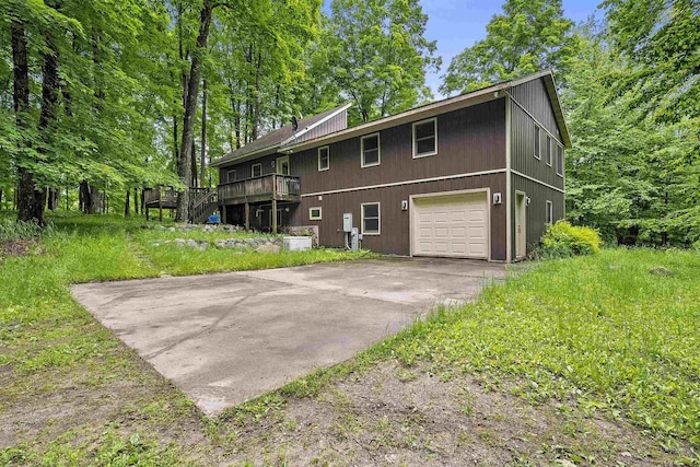 N12757 Rivers Meet Dr, Athelstane, WI 54104 - back of house featuring an attached garage, concrete driveway, and a wooden deck