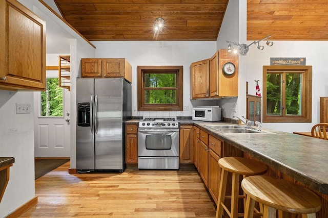 N12757 Rivers Meet Dr, Athelstane, WI 54104 - kitchen with appliances with stainless steel finishes, wooden ceiling, brown cabinets, light wood-style flooring, and vaulted ceiling