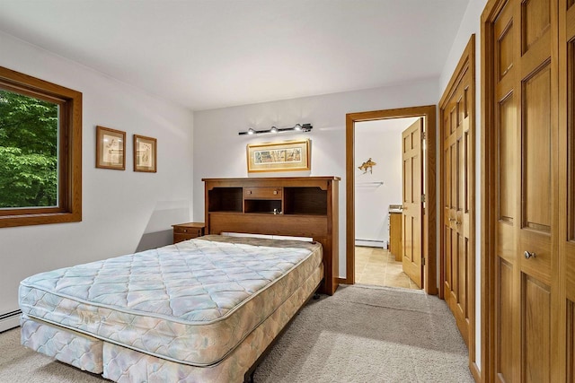 N12757 Rivers Meet Dr, Athelstane, WI 54104 - bedroom with light colored carpet, connected bathroom, and a baseboard radiator