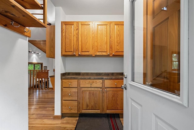N12757 Rivers Meet Dr, Athelstane, WI 54104 - kitchen featuring light wood-style floors, brown cabinets, and dark countertops