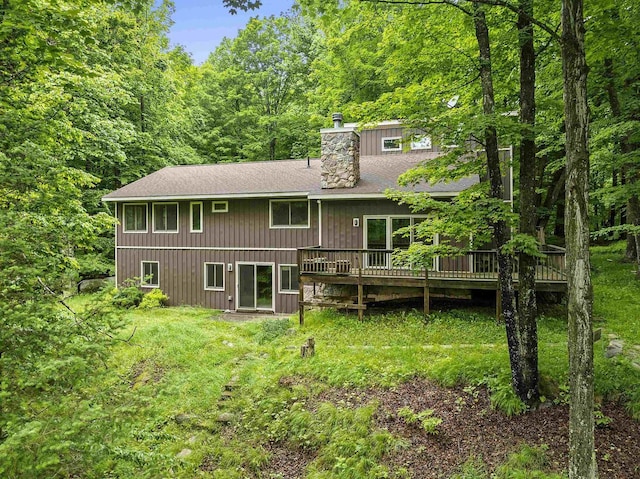 N12757 Rivers Meet Dr, Athelstane, WI 54104 - rear view of house with a chimney, a wooden deck, roof with shingles, and a forest view