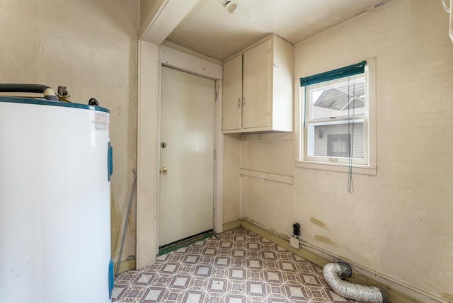 1647 Loomis St, La Crosse, WI 54603 - laundry room with water heater, light floors, and cabinet space