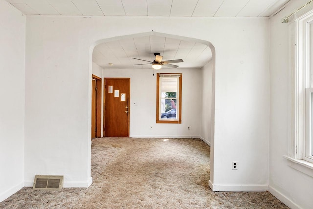 1647 Loomis St, La Crosse, WI 54603 - carpeted empty room featuring arched walkways and ceiling fan