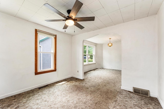 1647 Loomis St, La Crosse, WI 54603 - carpeted empty room featuring a chandelier, arched walkways, and ceiling fan