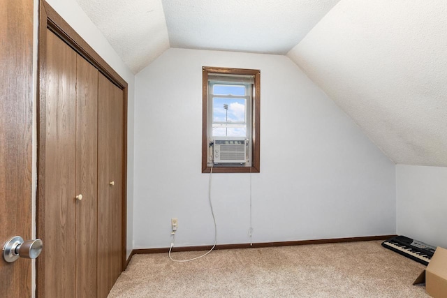 1432 Loomis St, La Crosse, WI 54603 - additional living space with lofted ceiling, cooling unit, carpet flooring, and a textured ceiling