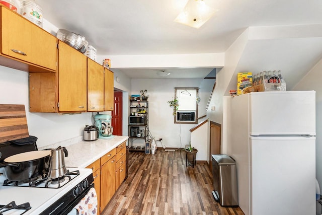 1432 Loomis St, La Crosse, WI 54603 - kitchen with white appliances, dark wood-style floors, light countertops, and brown cabinetry