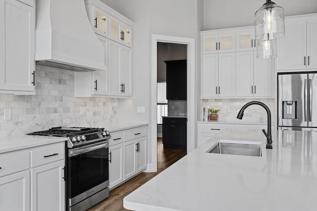 7205 N Trinity Ct, Appleton, WI 54913 - kitchen featuring custom exhaust hood, appliances with stainless steel finishes, white cabinets, pendant lighting, and dark wood finished floors
