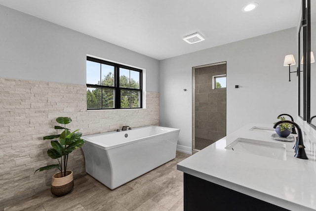 7205 N Trinity Ct, Appleton, WI 54913 - bathroom featuring a soaking tub, double vanity, and recessed lighting