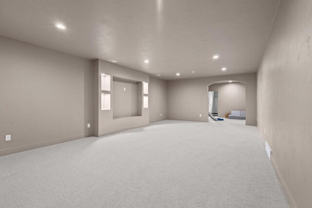 7205 N Trinity Ct, Appleton, WI 54913 - empty room with arched walkways, light colored carpet, and recessed lighting
