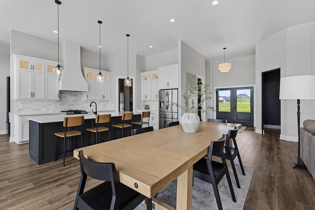 7205 N Trinity Ct, Appleton, WI 54913 - dining room featuring dark wood-style floors, a towering ceiling, and recessed lighting