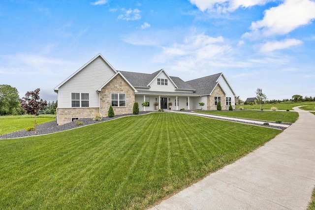 7205 N Trinity Ct, Appleton, WI 54913 - view of front of property with stone siding, a porch, and a front yard