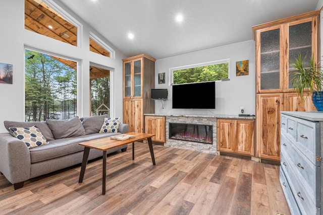 3838 Bear Lake Ln, Laona, WI 54541 - living room with lofted ceiling, light wood-style floors, a fireplace, and recessed lighting