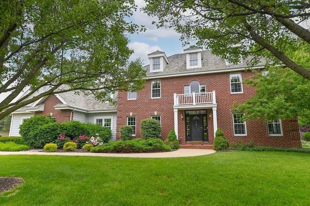 20750 Chadwick Ln, Brookfield, WI 53045 - colonial-style house featuring a balcony, a front lawn, and brick siding