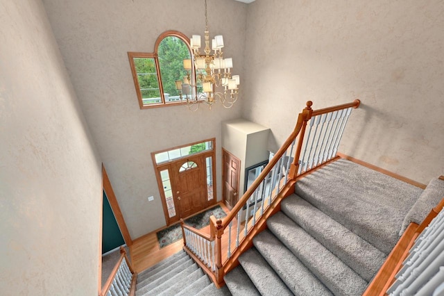 20750 Chadwick Ln, Brookfield, WI 53045 - entryway featuring a chandelier, stairs, wood finished floors, and a towering ceiling