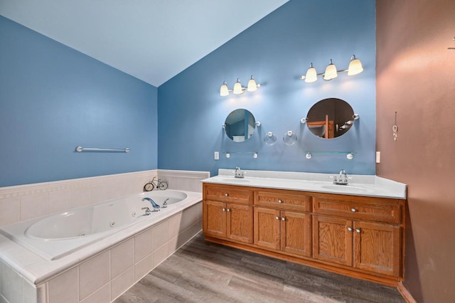 20750 Chadwick Ln, Brookfield, WI 53045 - bathroom featuring wood finished floors, double vanity, a whirlpool tub, and vaulted ceiling