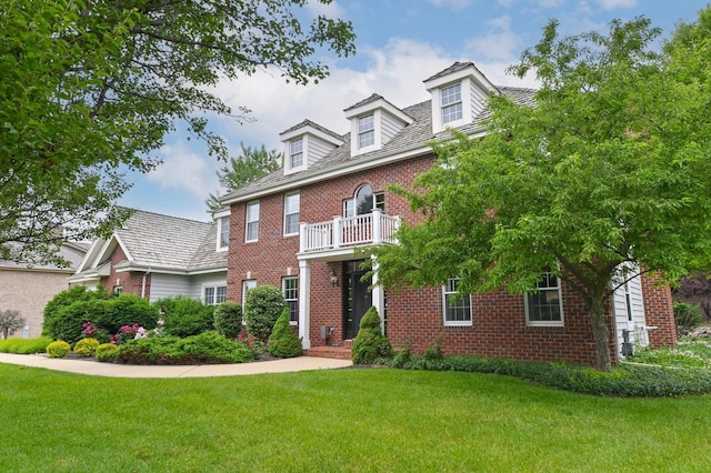 20750 Chadwick Ln, Brookfield, WI 53045 - colonial-style house with brick siding, a front lawn, and a balcony