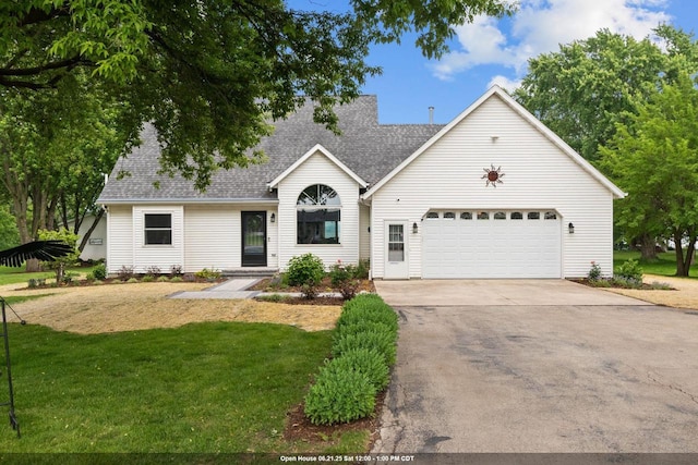 N7861 Lakeshore Dr, Fond Du Lac, WI 54937 - view of front of property with an attached garage, concrete driveway, a front yard, and roof with shingles