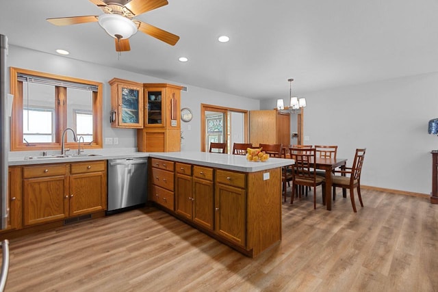 N7861 Lakeshore Dr, Fond Du Lac, WI 54937 - kitchen featuring stainless steel dishwasher, a peninsula, brown cabinets, light wood-style floors, and light countertops