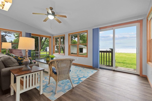 N7861 Lakeshore Dr, Fond Du Lac, WI 54937 - sunroom / solarium featuring vaulted ceiling, healthy amount of natural light, wood finished floors, and a deck with water view