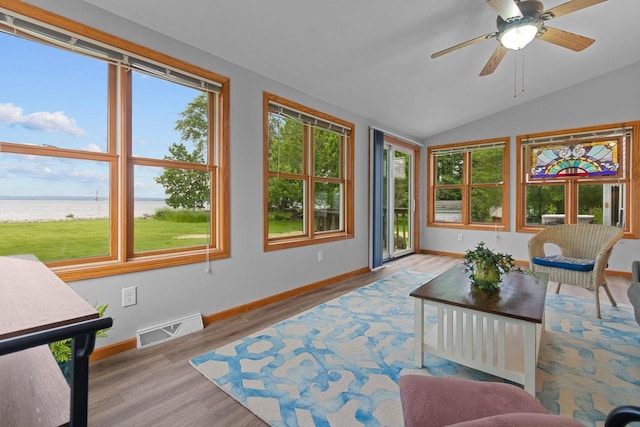 N7861 Lakeshore Dr, Fond Du Lac, WI 54937 - sunroom / solarium with a water view, plenty of natural light, vaulted ceiling, and wood finished floors