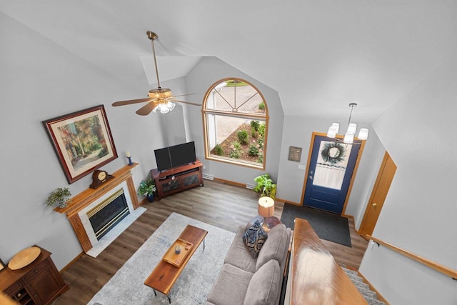 N7861 Lakeshore Dr, Fond Du Lac, WI 54937 - living room featuring lofted ceiling, wood finished floors, ceiling fan, and a fireplace with flush hearth