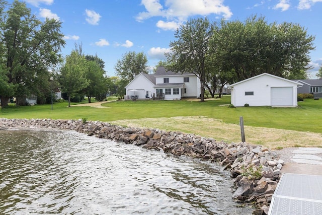 N7861 Lakeshore Dr, Fond Du Lac, WI 54937 - rear view of property featuring a lawn, a detached garage, an outdoor structure, and a water view