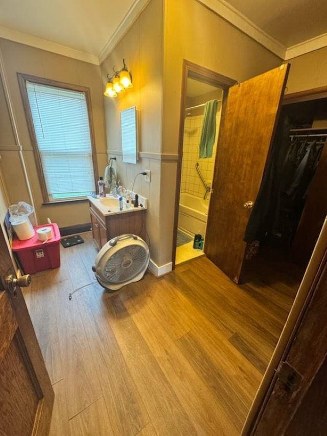 1820 Plymouth St, Oshkosh, WI 54901 - bathroom with wood finished floors, crown molding, vanity, and shower / washtub combination