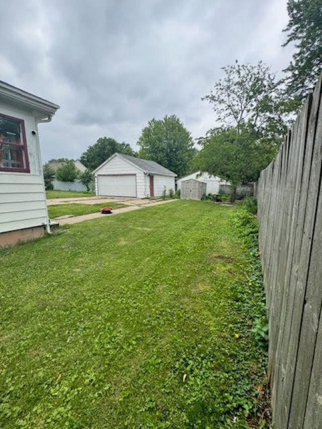 1820 Plymouth St, Oshkosh, WI 54901 - view of yard featuring a garage and an outdoor structure