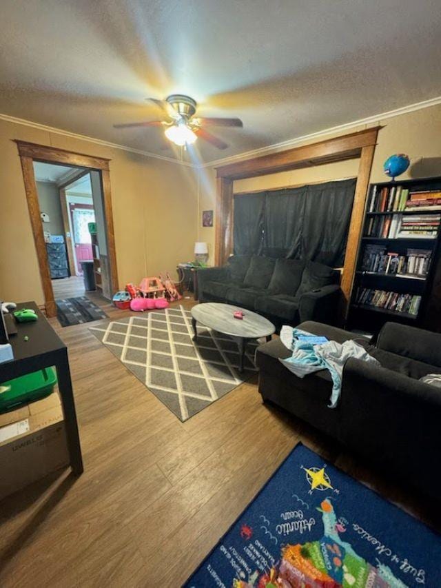1820 Plymouth St, Oshkosh, WI 54901 - living area featuring wood finished floors, ceiling fan, and ornamental molding