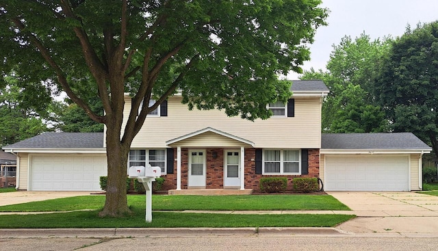 752 Imperial Ct Unit 754, West Bend, WI 53095 - view of front of home with an attached garage, concrete driveway, and a front lawn