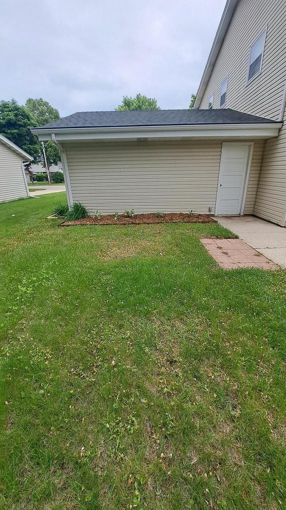 752 Imperial Ct Unit 754, West Bend, WI 53095 - view of side of home featuring a lawn