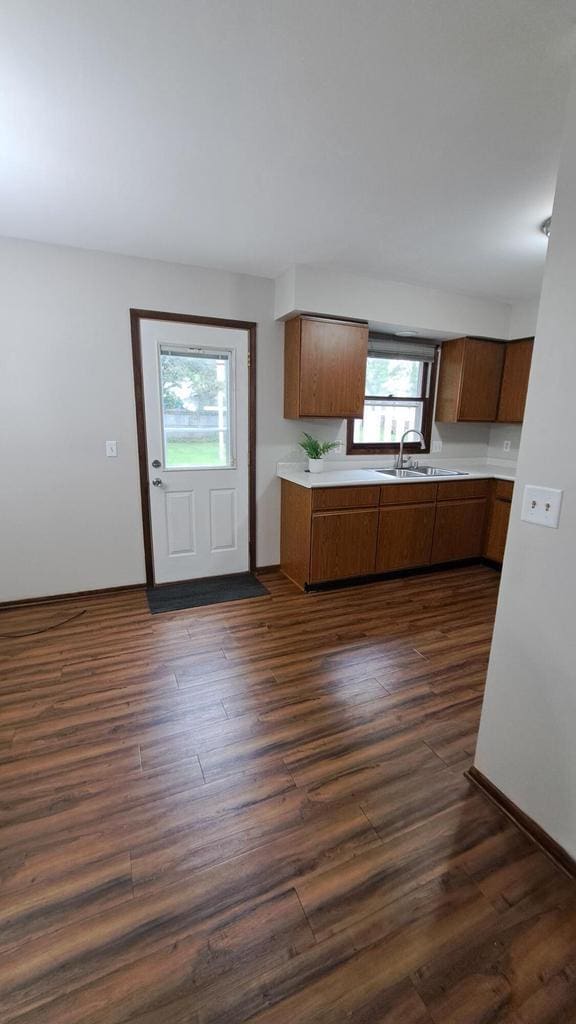 752 Imperial Ct Unit 754, West Bend, WI 53095 - kitchen featuring light countertops, dark wood finished floors, and brown cabinetry