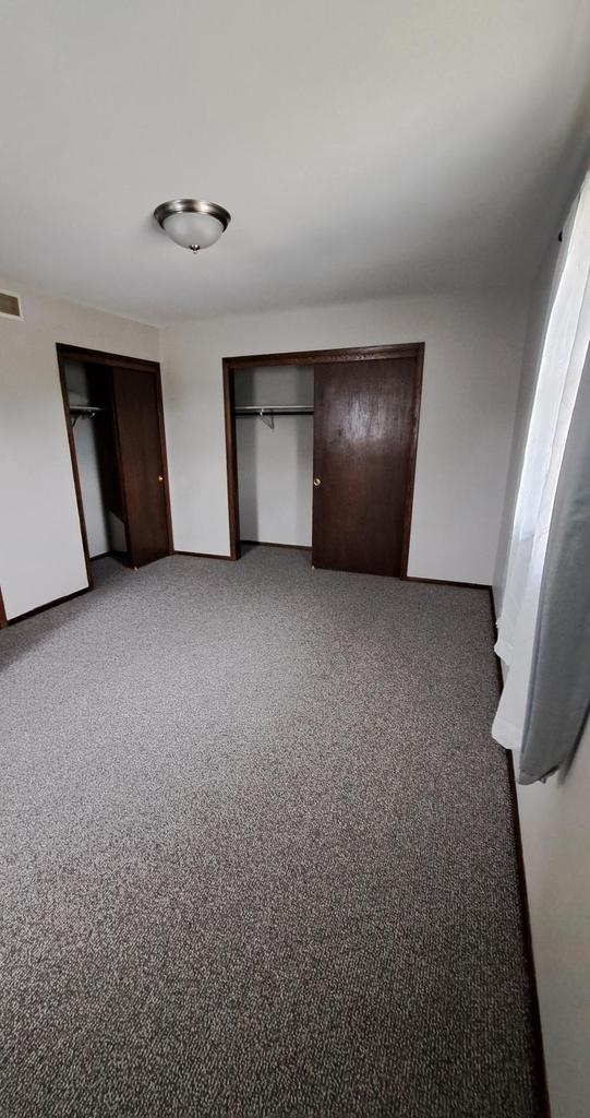 752 Imperial Ct Unit 754, West Bend, WI 53095 - unfurnished bedroom with baseboards